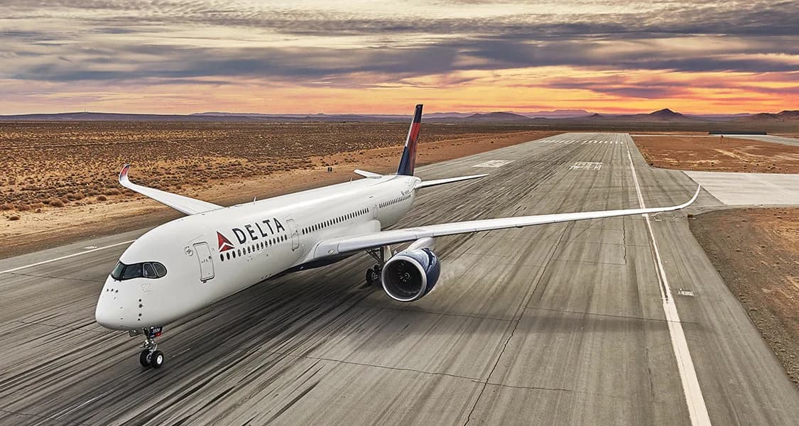 A Delta Airbus A350 on a desert runway at sunset