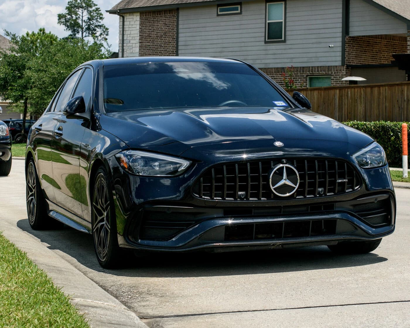 Black 2024 Mercedes-AMG C43 from the front three-quarter after a maintenance wash