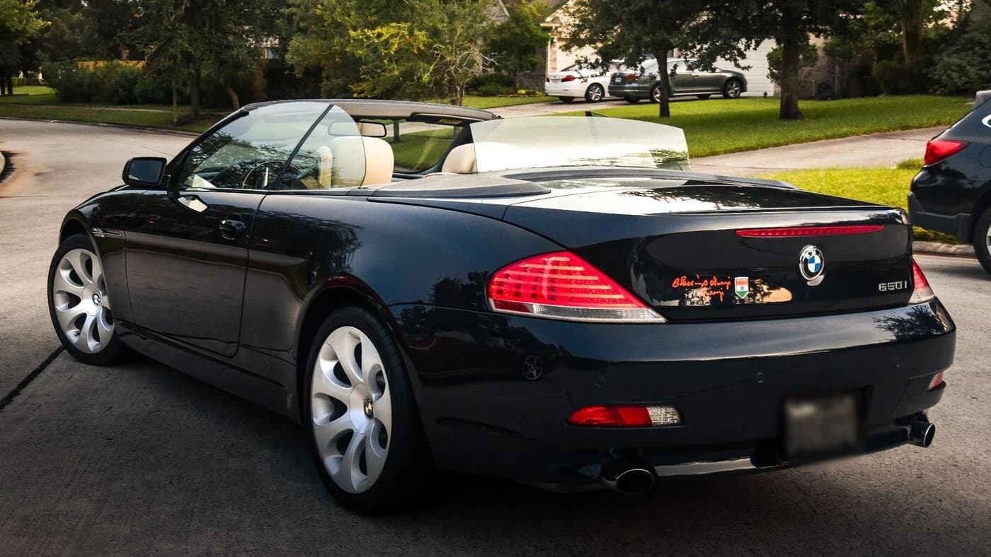 Black 2006 BMW 650i convertible from the rear three-quarter, ceramic coated