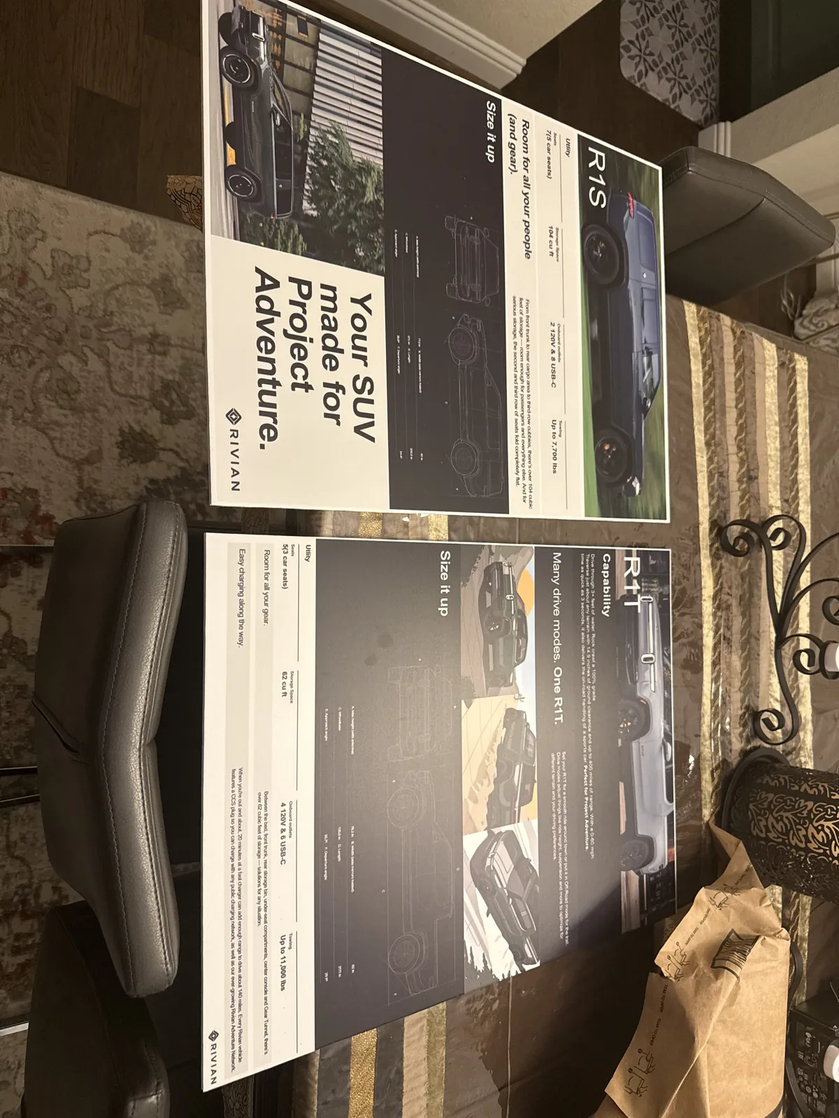 Printed Project Adventure posters laid out on a table