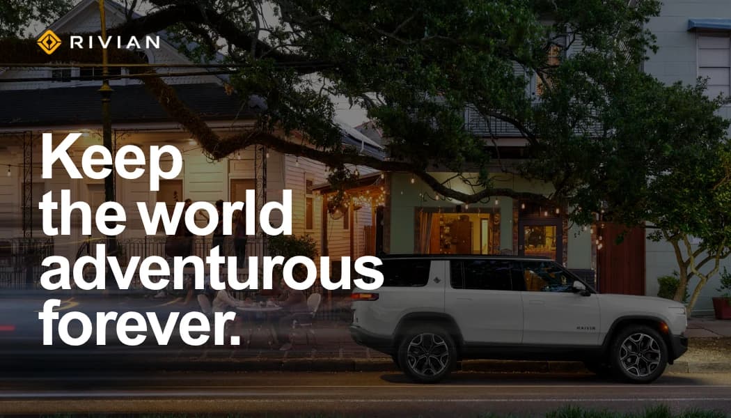 Front of the team's business card: 'Keep the world adventurous forever' over a Rivian R1T