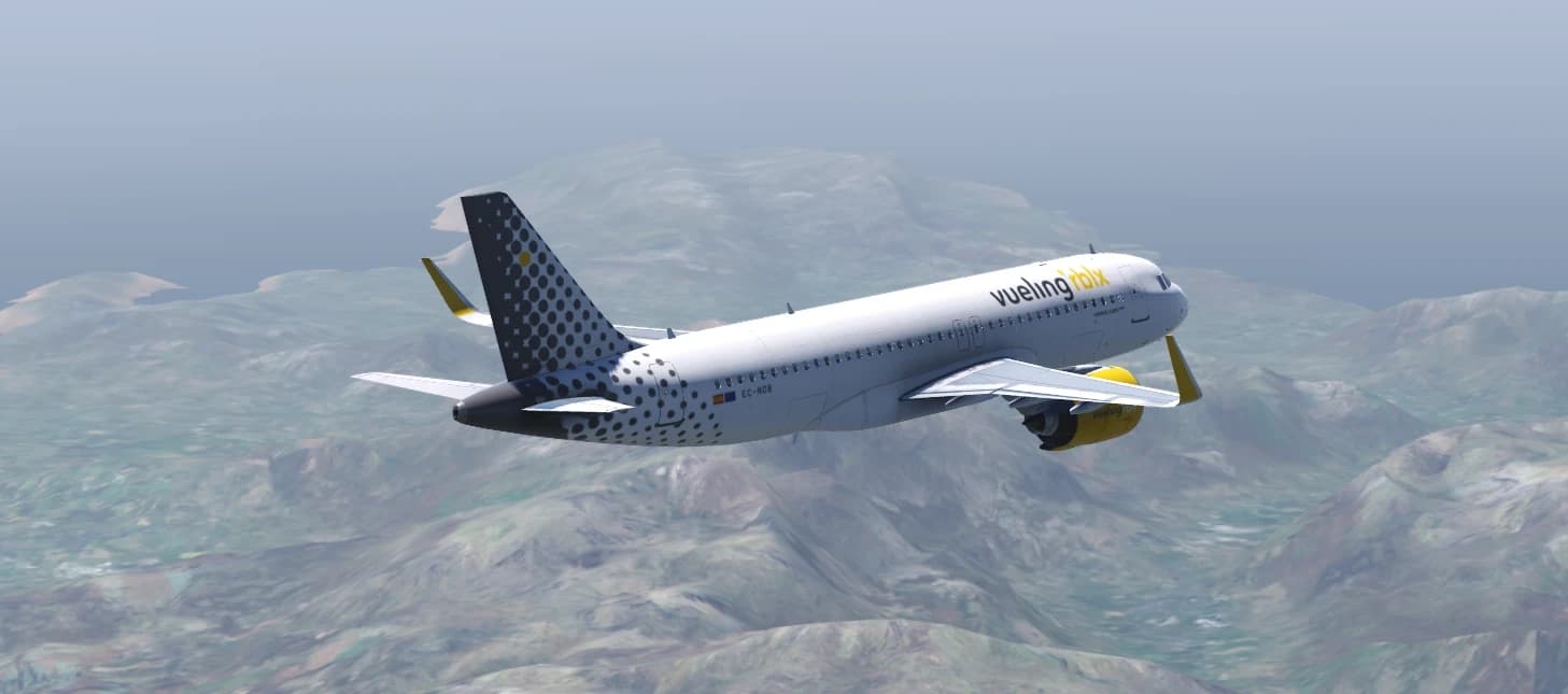 A Vueling A320neo flying over green mountains